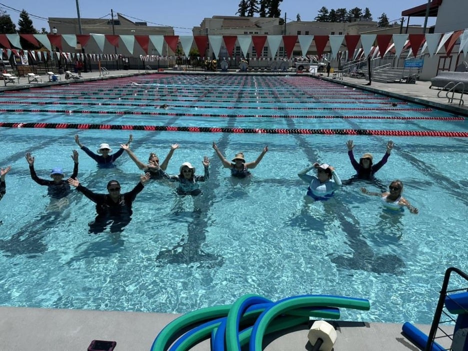 Aqua aerobics group celebrating in pool